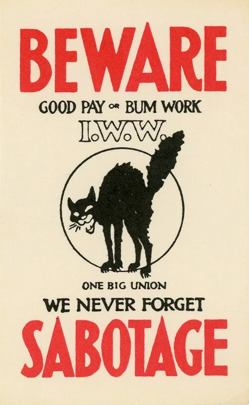 An Industrial Workers of the World poster with a black cat in a threatening position in the center.