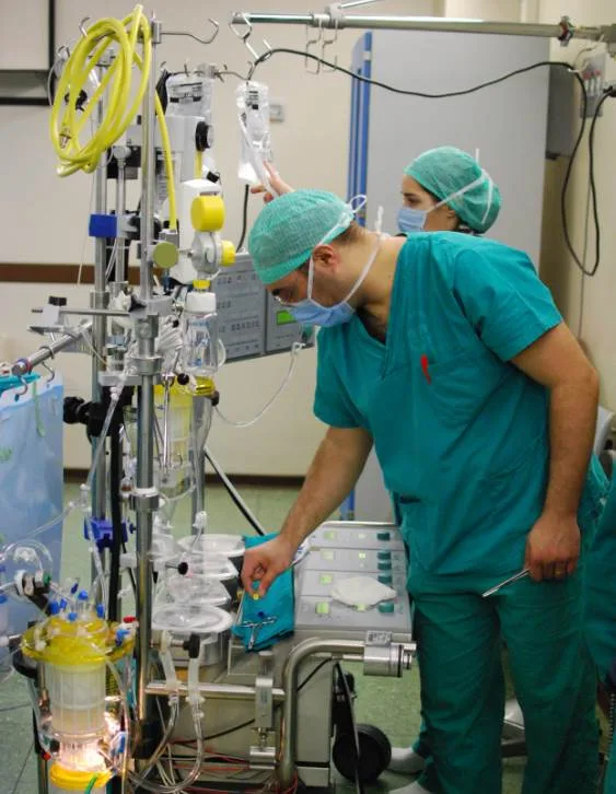 Perfusionist operating a modern heart lung machine
