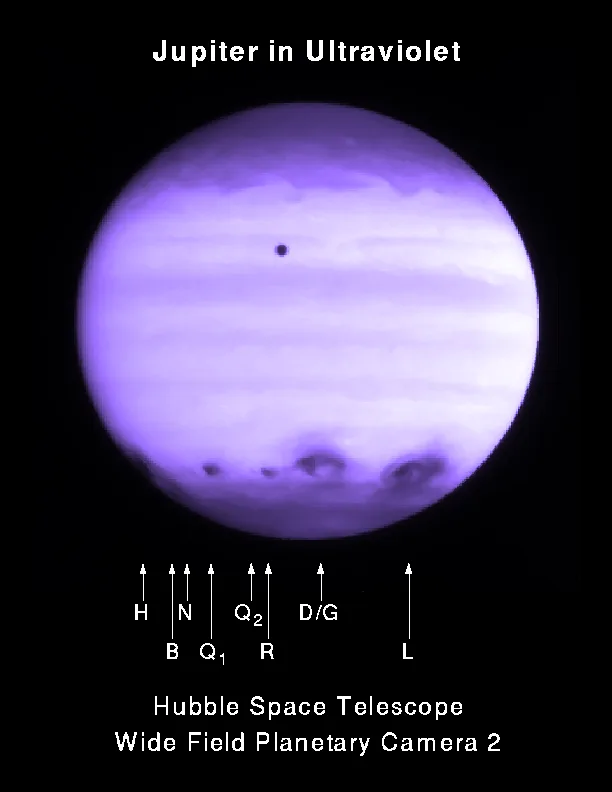 Jupiter in ultraviolet (about 2.5 hours after R's impact). The black dot near the top is Io transiting Jupiter.[18]