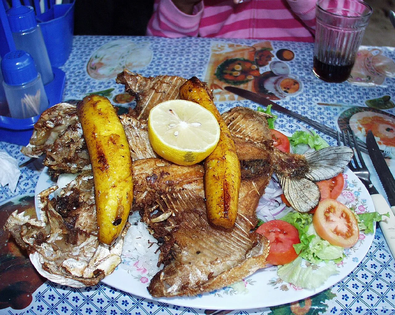 Plantains served over fried pacu (Bolivia)
