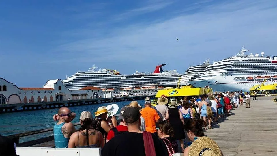 Multiple cruise ships docked in Cozumel. From left to right: Carnival Breeze, unnamed Holland America ship, and Carnival