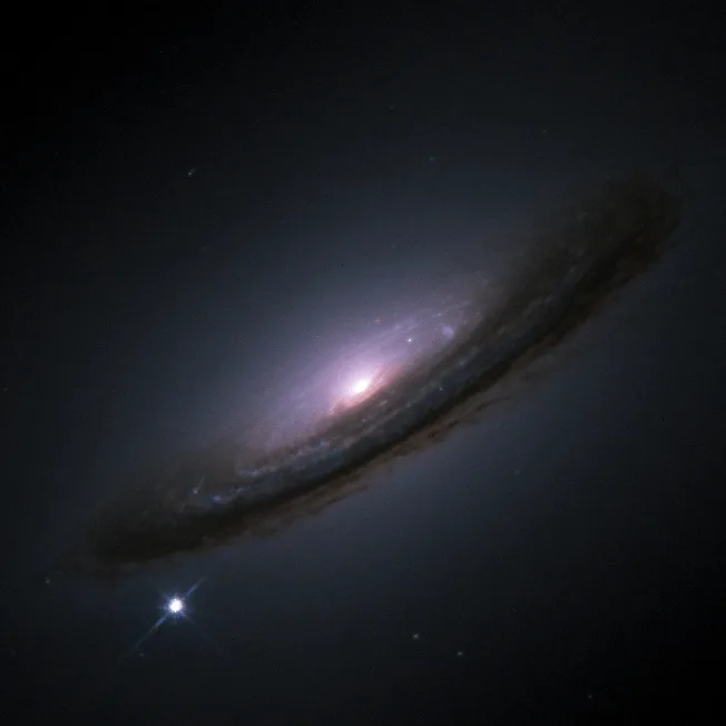 A Type Ia supernova (bright spot on the bottom-left) near NGC 4526