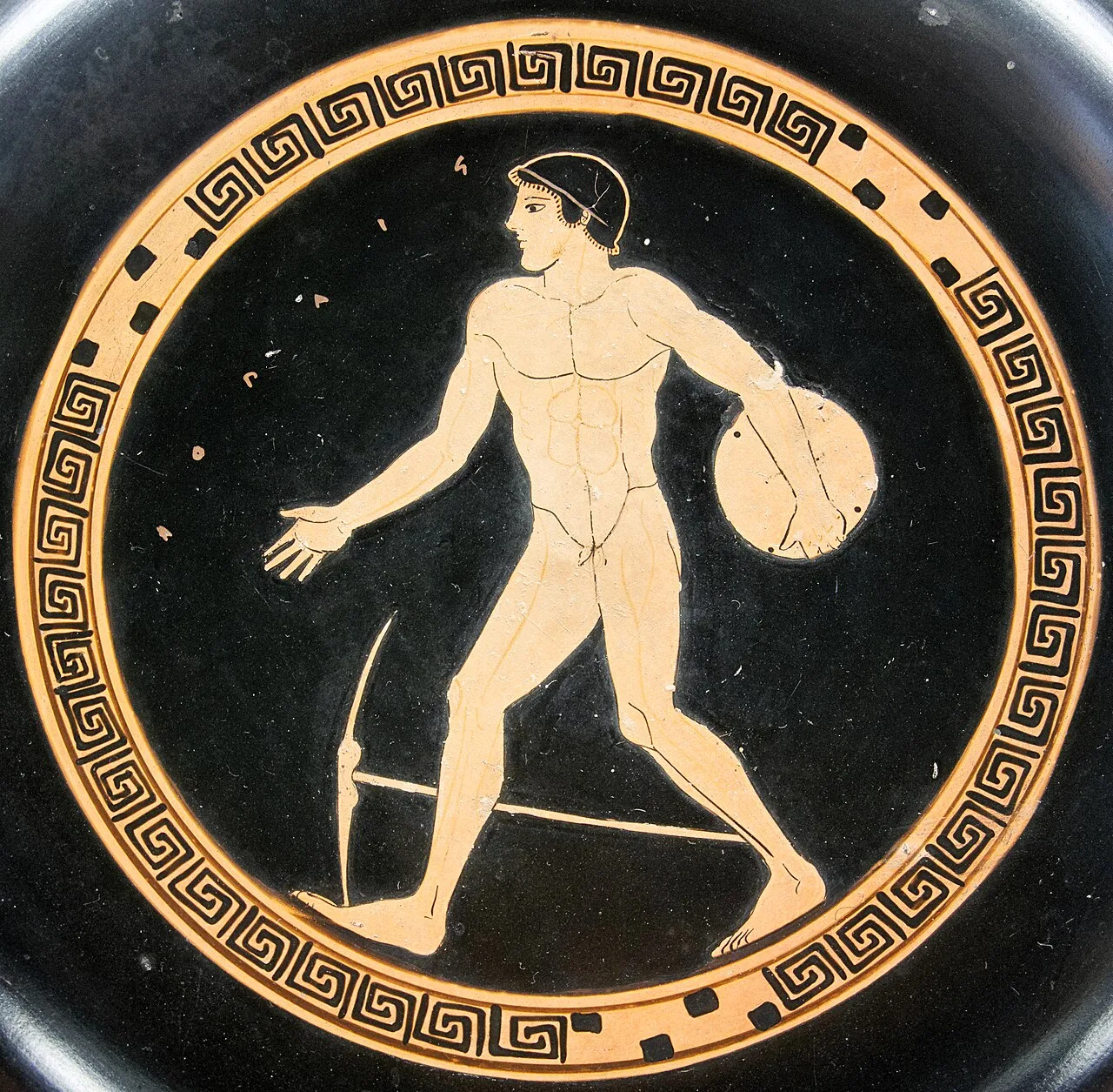 The discobolus motif on an Attic red-figured cup, c. 490 BC, is static by comparison.