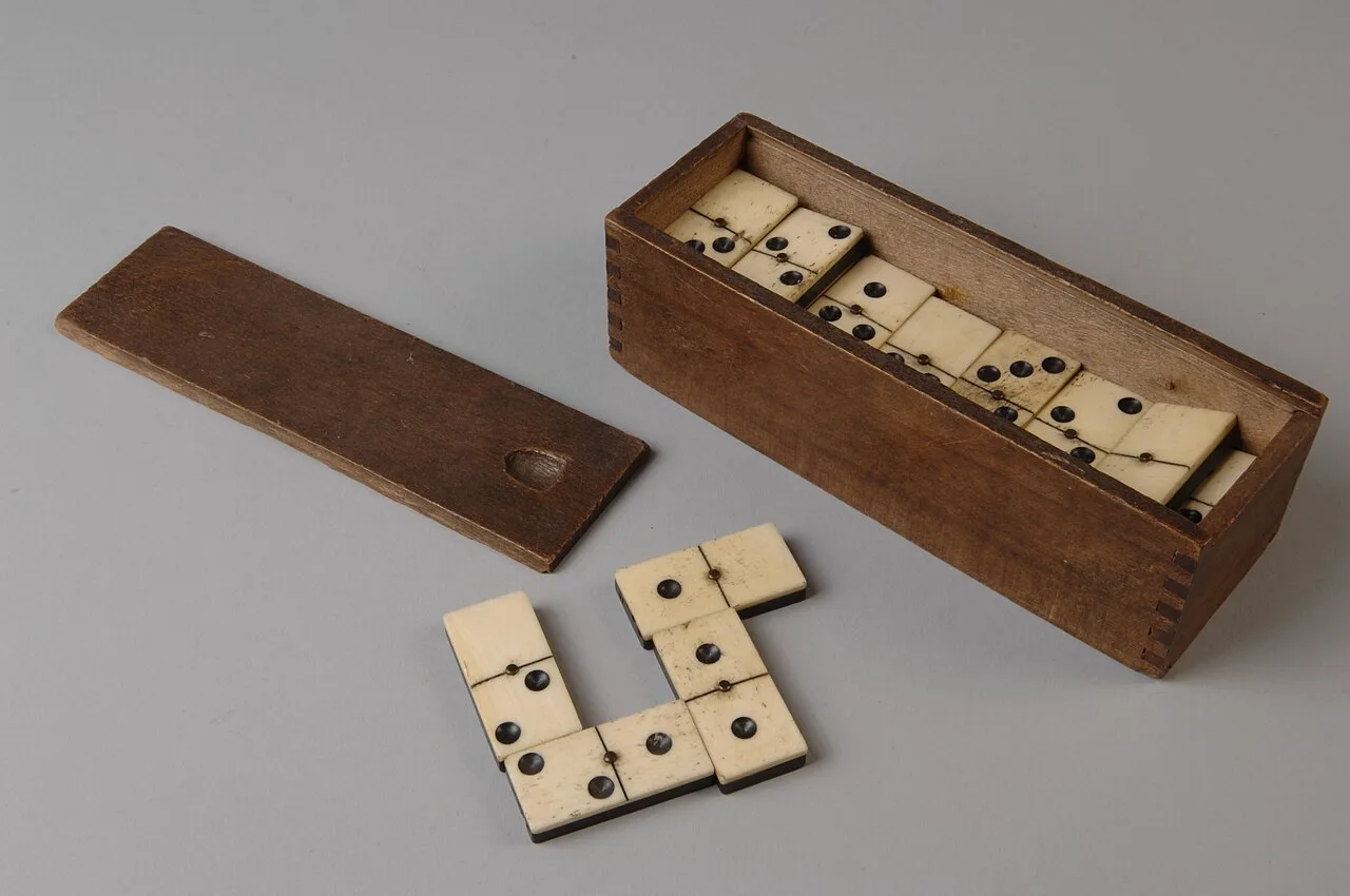 A boxed domino set dating from the late 19th or early 20th century