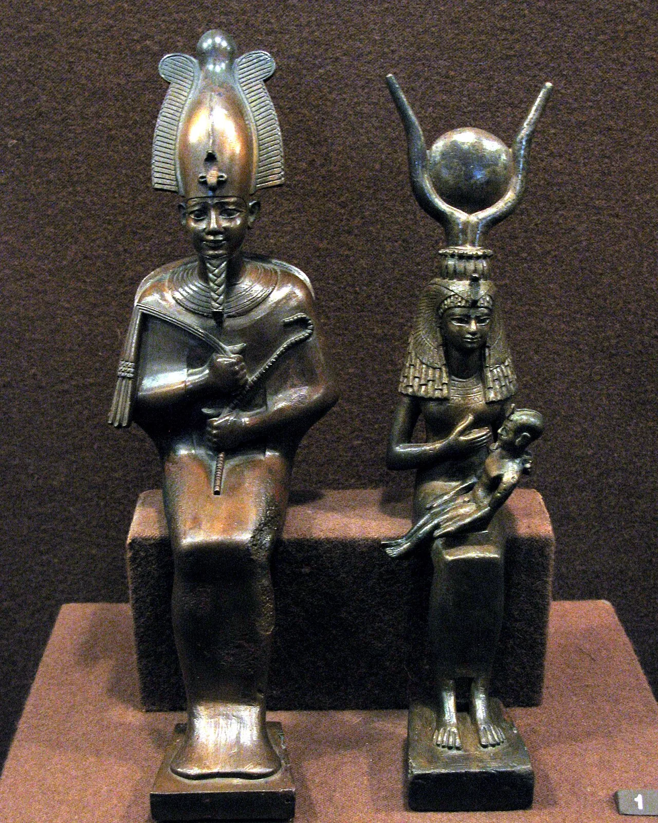 Statues of Osiris and of Isis nursing the infant Horus