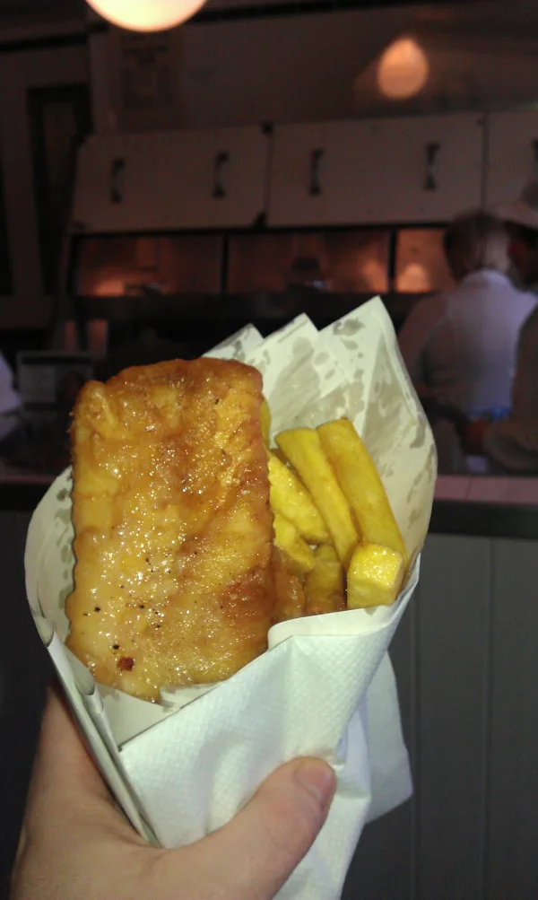 Fish and chips, served in a paper wrapper (greaseproof paper inner and ordinary paper outer), as a takeaway