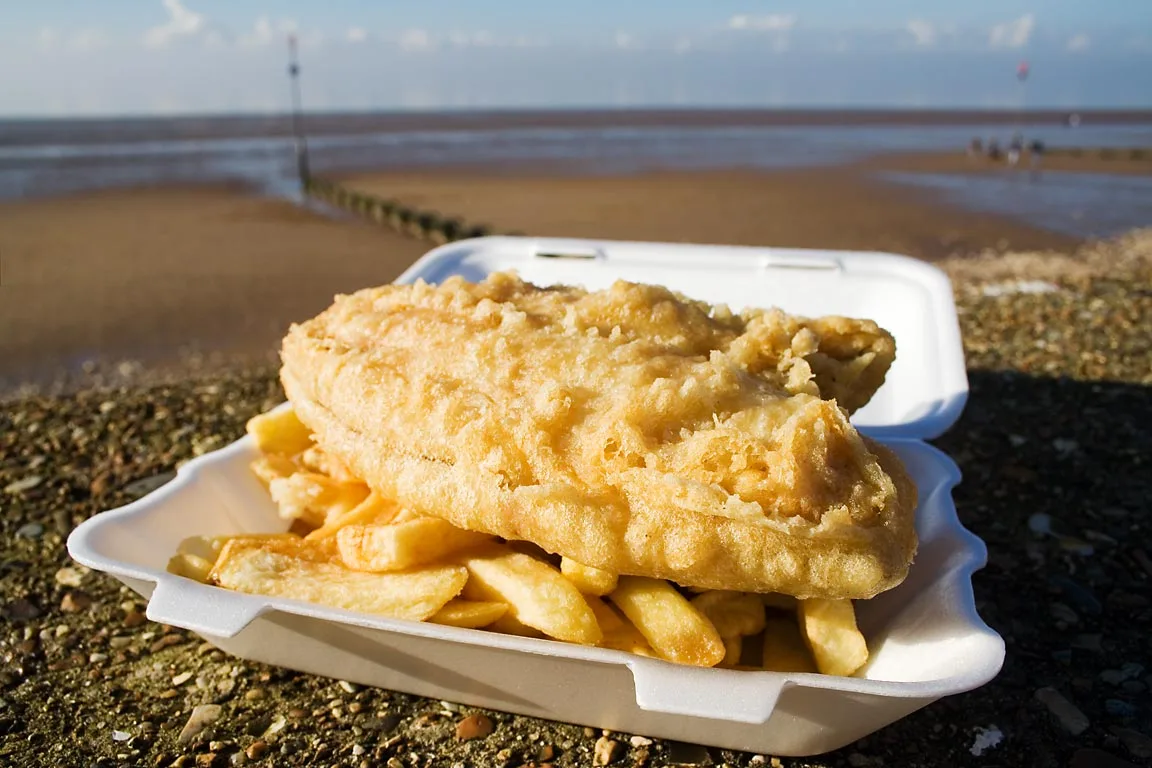 Fish and chips on the seafront at Hunstanton, Norfolk. In the UK, fish and chips are particularly associated with seasid