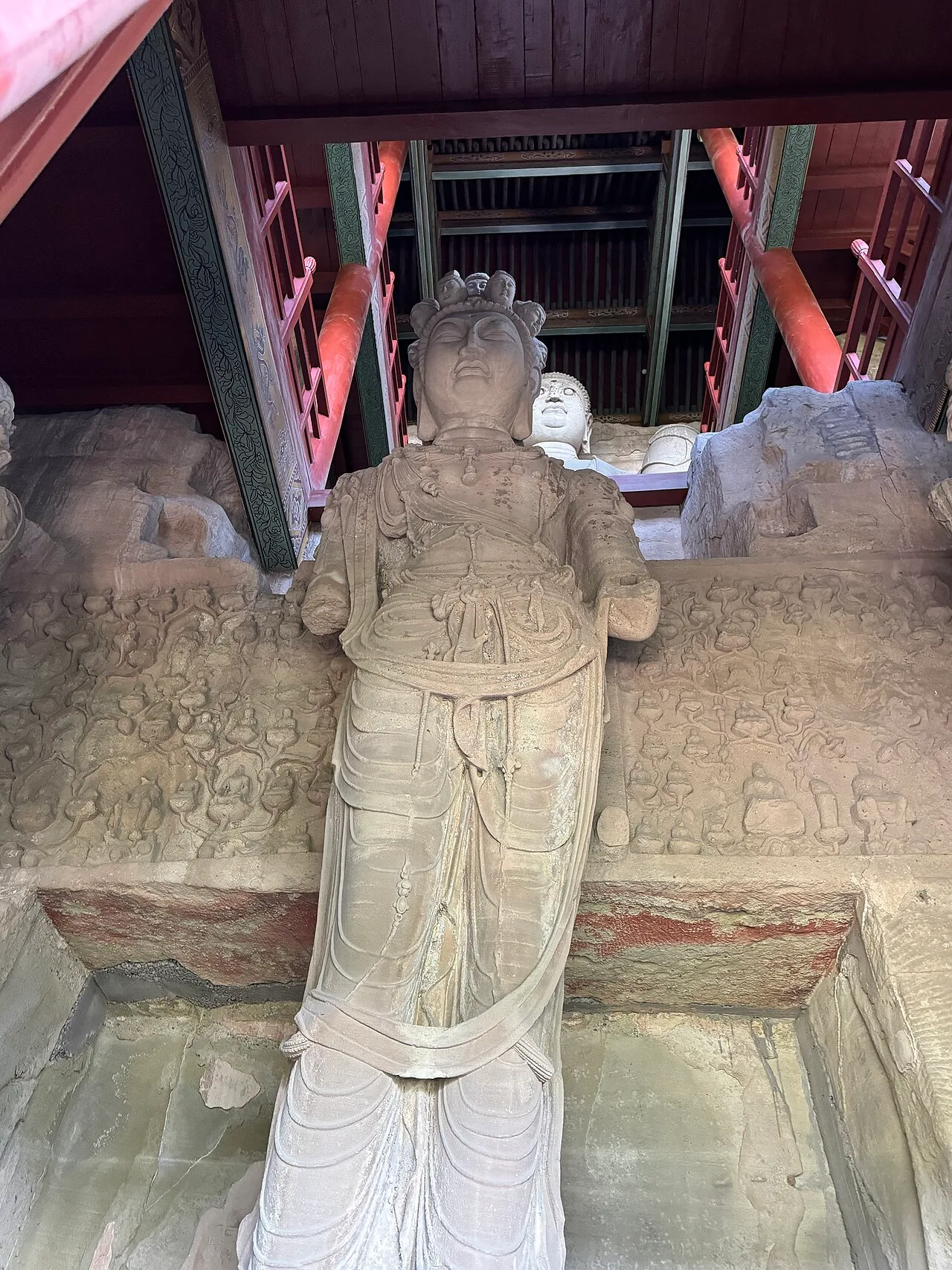 Statue of Shiyimian Guanyin, flanked by the Bodhisattvas Wenshu and Puxian at Tianlongshan Grottoes in Shanxi, China.