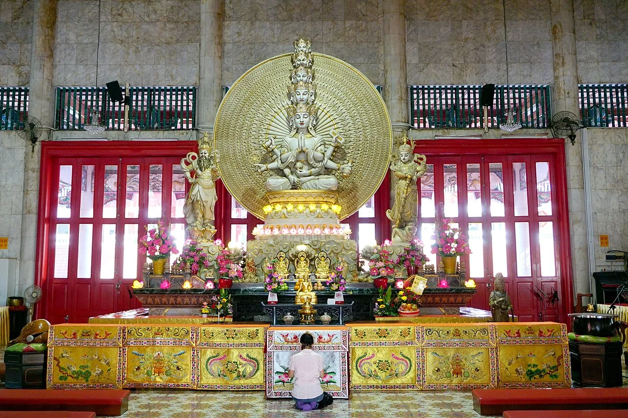 Statue of Qianshou Qianyan Guanyin flanked by the dharmapalas Weituo and Qielan at Kong Meng San Phor Kark See Monastery in Singapore.