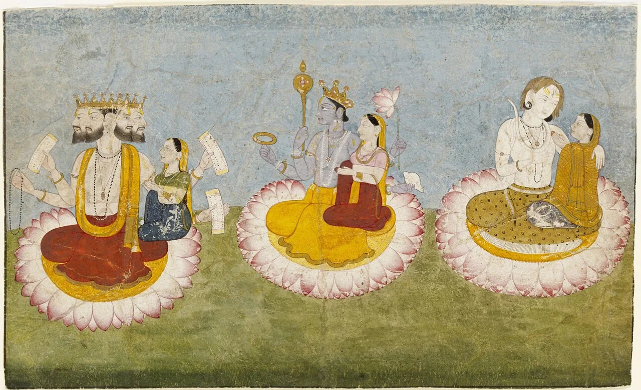 The Trimurti (Brahma, Vishnu, and Shiva) seated on lotuses with their consorts, the Tridevi (Saraswati, Lakshmi, and Par