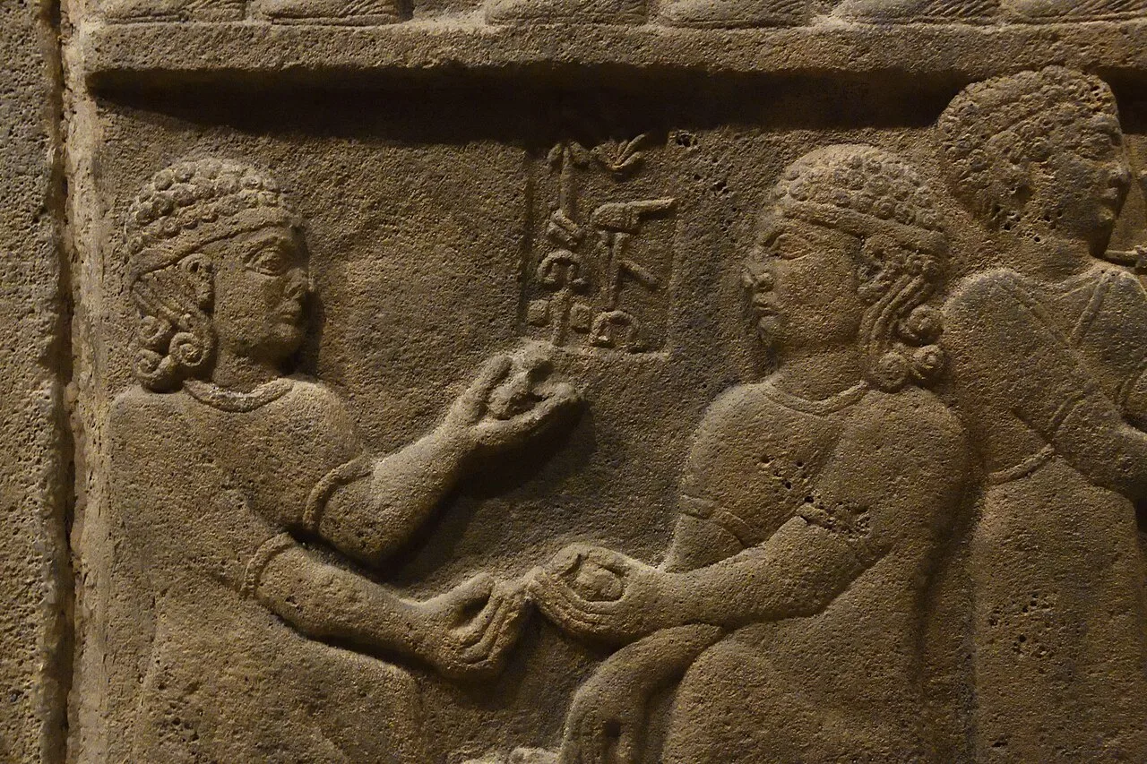 An orthostat depicting people playing knucklebones from Carchemish (c. 8th century BCE)