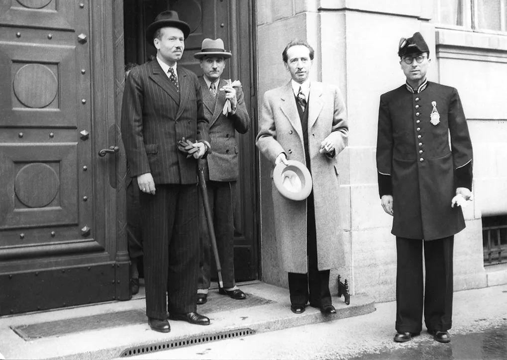 Four men standing outside the Federal Palace of Switzerland in 1943. From left is Franz Joseph II, Marcel Pilet-Golaz, Enrico Celio, and an unknown guard.