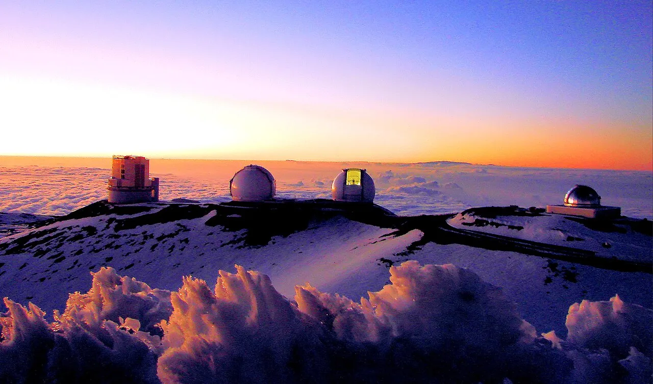 Sunset over four telescopes of the Maunakea Observatories. From left to right: the Subaru Telescope, the twin Keck I and