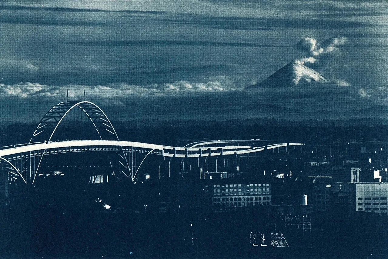 Mount St. Helens during an eruption prior to May 18, as viewed from Portland, Oregon. The Fremont Bridge is visible in t