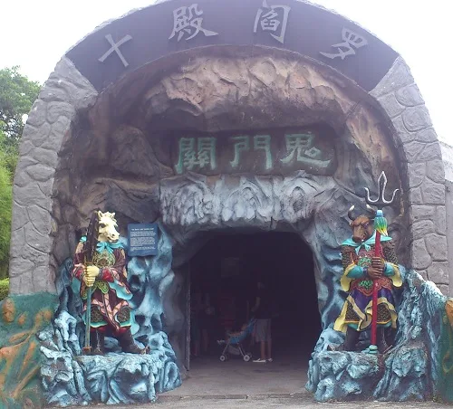 Entrance to the "Ten Courts of Hell" attraction in Haw Par Villa, Singapore. The Ox-Headed (right) and Horse-Faced (left
