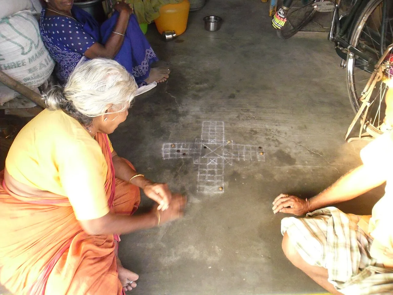 Pachisi being played in Tamil Nadu with tamarind seeds and stones