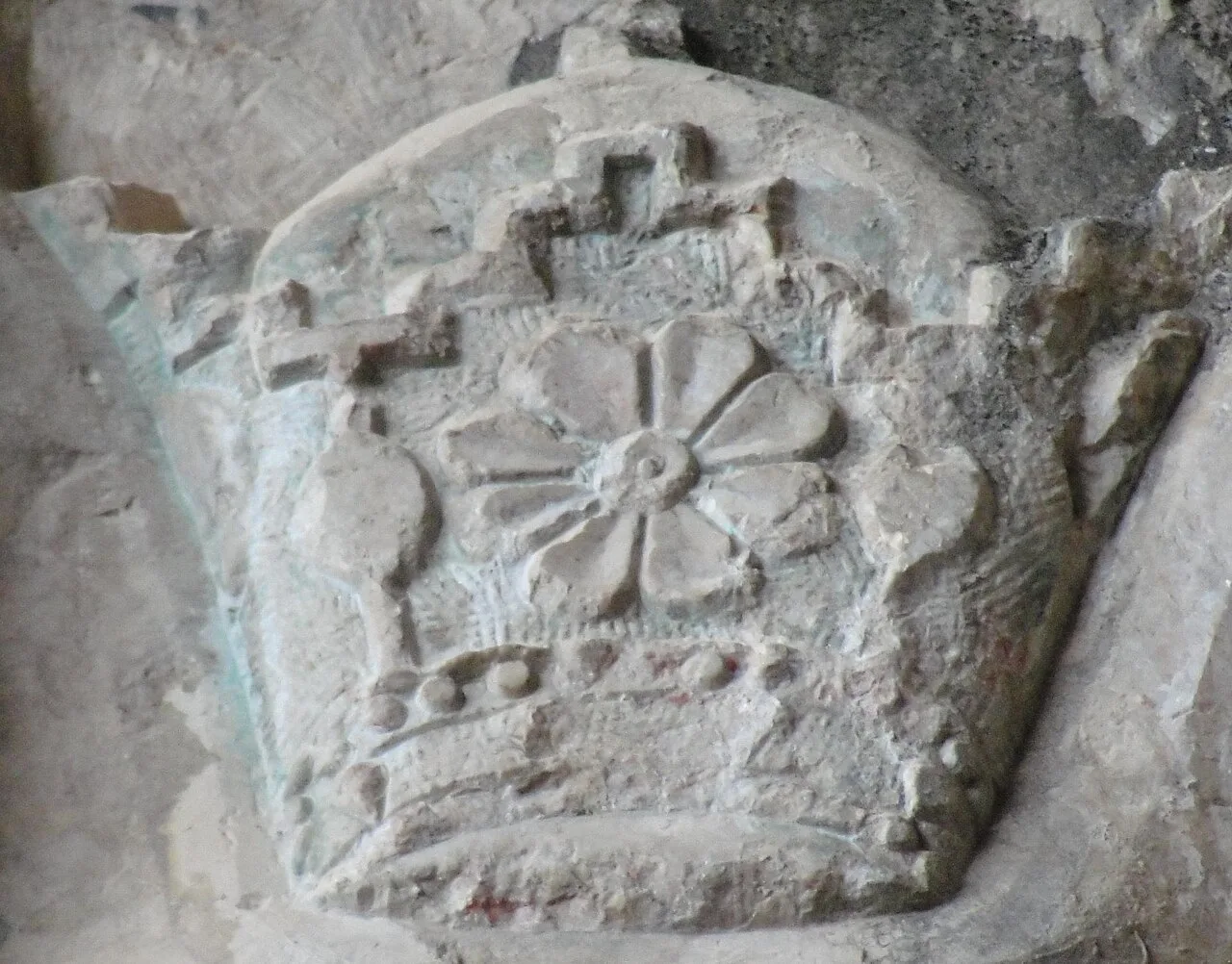 The crown engraved above a 1957 inscription at Shapur Cave