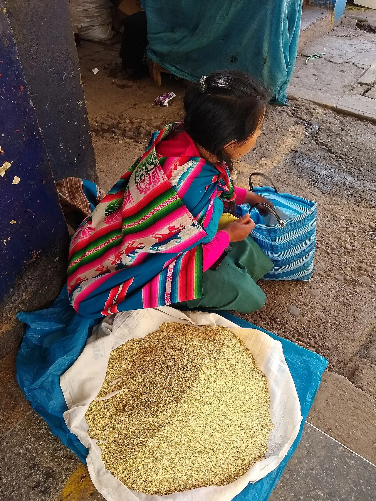 Quinoa seller at market in Calca, Peru