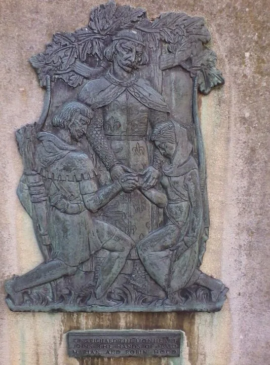 King Richard the Lionheart marrying Robin Hood and Maid Marian on a plaque outside Nottingham Castle
