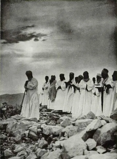 Samaritans pray before the Holy Rock on Mount Gerizim.
