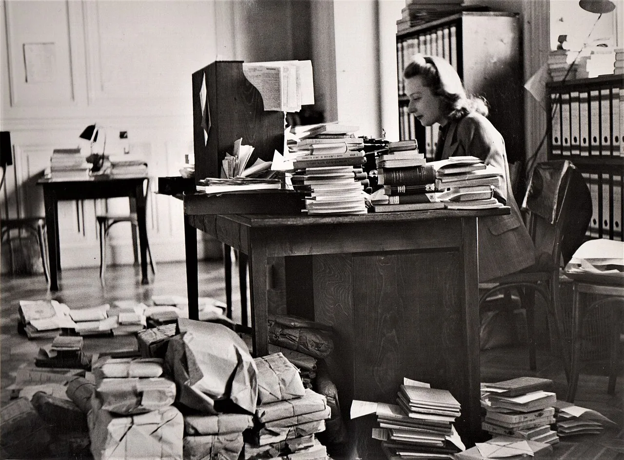 A photograph from the International Bureau of Education Archives showing the preparation of parcels and books for distri