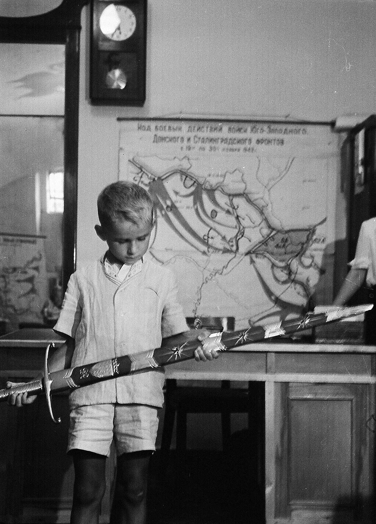 A boy inspects the Sword of Stalingrad in the Battle of Stalingrad Museum, 1953.