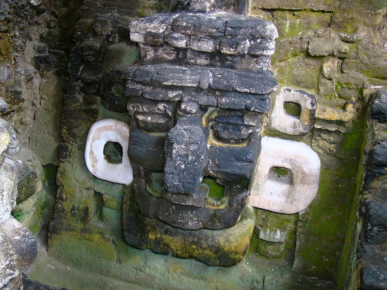 A large stucco mask adorning the substructure of Temple 33