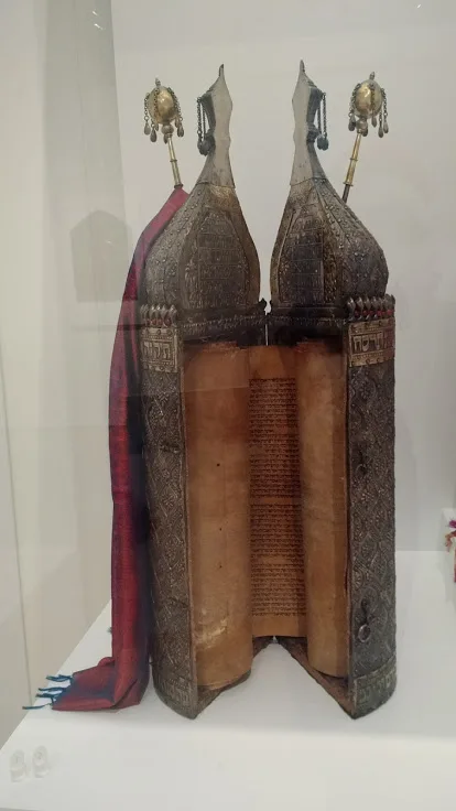 An old open Torah case with scroll.