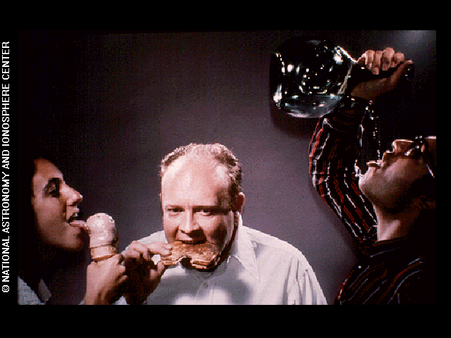 Depiction of humans licking, eating, and drinking as modes of consumption